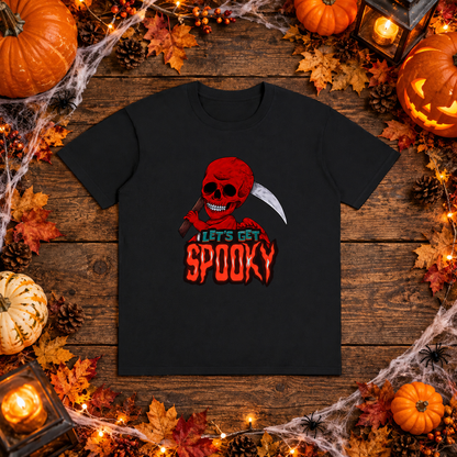 Black Let's Get Spooky reaper T-shirt in a Halloween flat lay with pumpkins